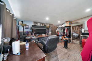 Office with a textured ceiling and hardwood / wood-style flooring