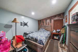 Bedroom featuring wooden walls