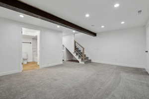 Basement with light colored carpet