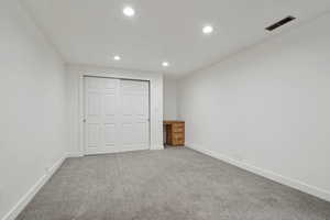 Unfurnished bedroom with carpet flooring and a closet