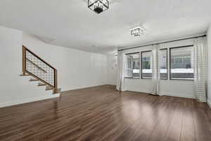 Unfurnished living room featuring dark hardwood / wood-style flooring