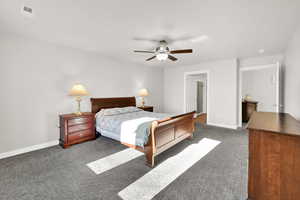 Carpeted bedroom with ceiling fan