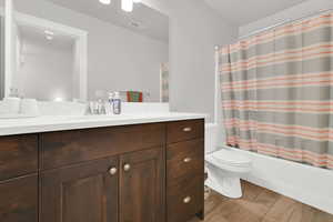 Full bathroom featuring vanity, toilet, and shower / bath combo with shower curtain