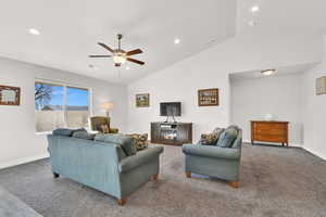 Living room with ceiling fan and vaulted ceiling