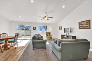 Living room featuring ceiling fan and lofted ceiling