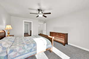 Bedroom featuring ceiling fan and carpet floors