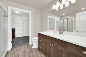 Bathroom featuring vanity, toilet, and walk in shower