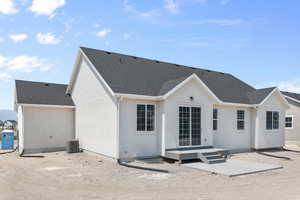 Rear view of property featuring central air condition unit