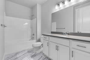 Full bathroom with toilet, vanity, and bathing tub / shower combination