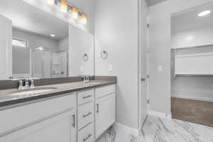 Bathroom featuring vanity and an enclosed shower