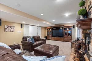 Carpeted living room with a fireplace