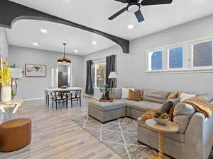 Living room with light wood-type flooring and ceiling fan