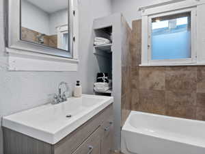 Bathroom featuring shower / bathing tub combination and vanity