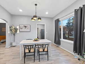 Dining room with a healthy amount of sunlight and light wood-type flooring