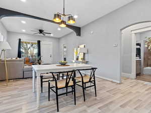 Dining room featuring light hardwood / wood-style flooring and ceiling fan with notable chandelier