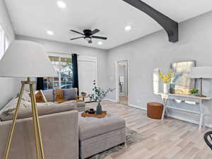 Living room with ceiling fan and light wood-type flooring