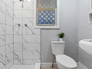 Bathroom with a tile shower and toilet