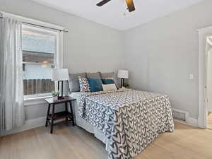 Bedroom featuring windows, ceiling fan, and light wood-type flooring