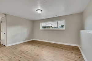 Unfurnished room with light wood-type flooring