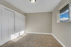 Unfurnished bedroom featuring carpet flooring