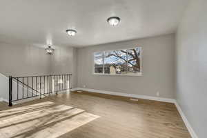 Unfurnished room with light hardwood / wood-style flooring