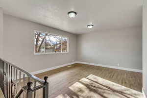 Unfurnished room with hardwood / wood-style flooring