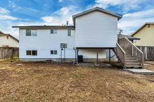 Rear view of property featuring central AC unit