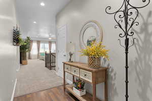 Corridor with hardwood / wood-style flooring