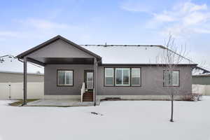 View of snow covered back of property