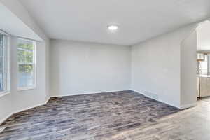 Empty room with hardwood / wood-style floors