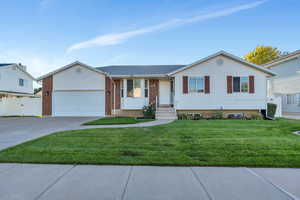 View of front facade with a garage and a front lawn