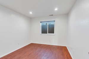 Unfurnished room with dark hardwood / wood-style flooring