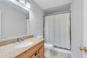 Bathroom featuring tile patterned floors, vanity, and toilet