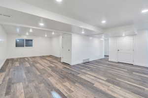 Basement featuring dark wood-type flooring