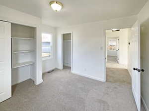 Unfurnished bedroom featuring light carpet