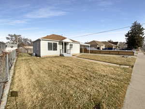 Exterior space with a front yard and central AC unit