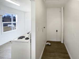 Clothes washing area with dark hardwood / wood-style floors