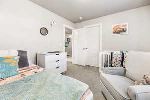 Bedroom featuring light colored carpet