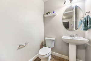 Bathroom featuring hardwood / wood-style floors, toilet, and sink