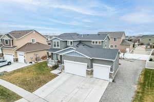 View of front of home with a porch, a garage, and a front yard