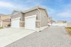 View of property exterior featuring a garage