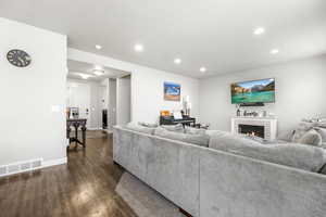 Living room featuring dark hardwood / wood-style flooring