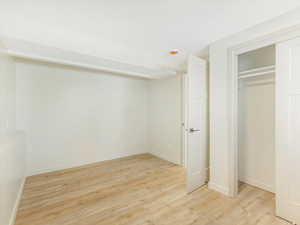 Unfurnished bedroom with a closet and light hardwood / wood-style flooring