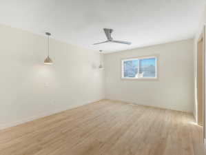 Unfurnished room with ceiling fan and light hardwood / wood-style floors