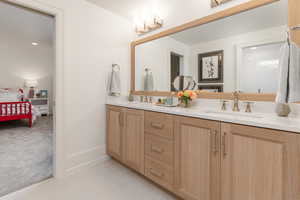 Bathroom with tile patterned flooring, vanity, and a chandelier