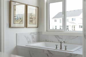 Bathroom featuring tiled bath