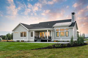 Back house at dusk with a lawn