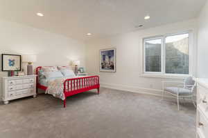 Carpeted bedroom featuring a textured ceiling