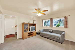 Sitting room featuring ceiling fan and light colored carpet