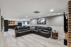 Living room with light hardwood / wood-style flooring